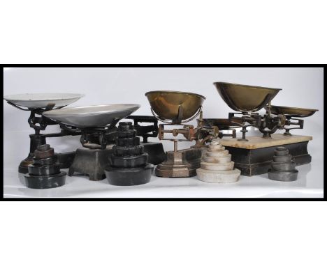 A collection of four 19th Century balance scales, and weights, three of the scales of cast metal structure and the other on a