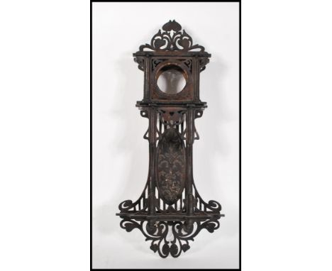 A early 20th Century Edwardian Black Forest style mahogany wall hanging clock case, having fret pierced foliate and swirl dec