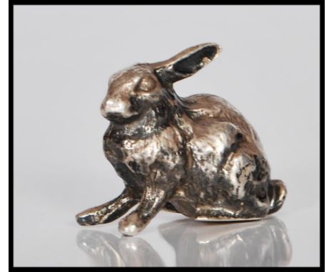 A 20th Century silver hallmarked figure in the form of a rabbit. Hallmarkes to base for London date letter R 1991. Makers mar