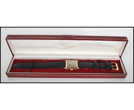 A vintage 20th Century Art Deco style 9ct gold gents tank wrist watch, silver and champagne two tone face with baton markers,