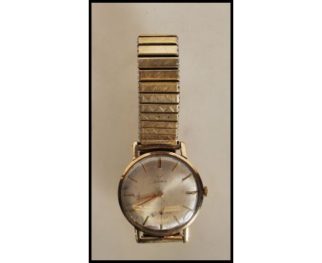 A vintage mid 20th Century Cyma 9ct gold case wrist watch having a round face with a silvered dial, gilt baton markers to the