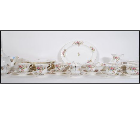 An extensive Royal Albert Moss Rose dinner / tea service to include plates, cups and saucers, tea pot, milk jug, serving dish