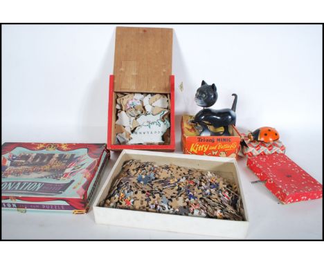 A collection of vintage toys to include a Tri-ang Minic Kitty and Butterfly clockwork novelty kitten, a Triang Minic toy lady