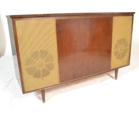 A vintage retro 20th Century walnut cased radiogram by Bush, central walnut panel flanked by speakers with split lift up top,