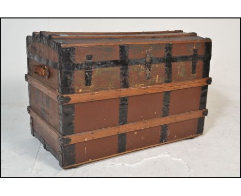 A Victorian 19th century wooden and canvas bound large dome top steamer trunk. Brown canvas with wooden strapping having leat