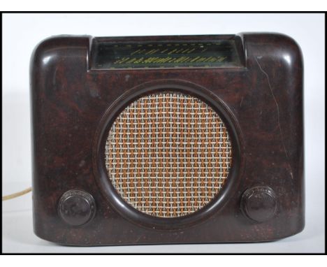 A vintage 1940's bakelite Bush radio type DAC. 90. having central round speaker with tuning and volume knob below, tuning win