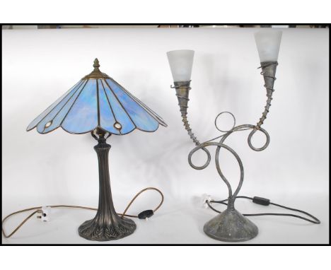 An antique style Tiffany type table lamp with naturalistic column base having stained and leaded glass Art Nouveau shade toge