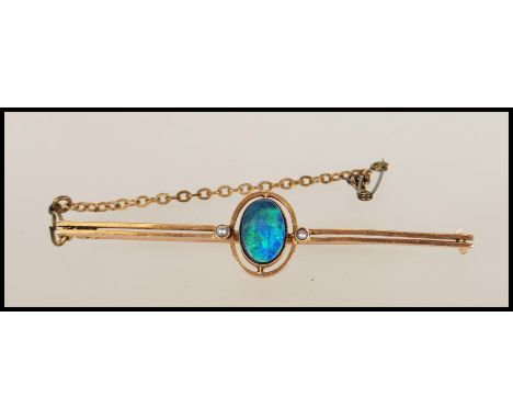 A 9ct gold and black opal doublet ladies bar brooch. The brooch with twin bar, central cabochon opal with pin verso. Total we