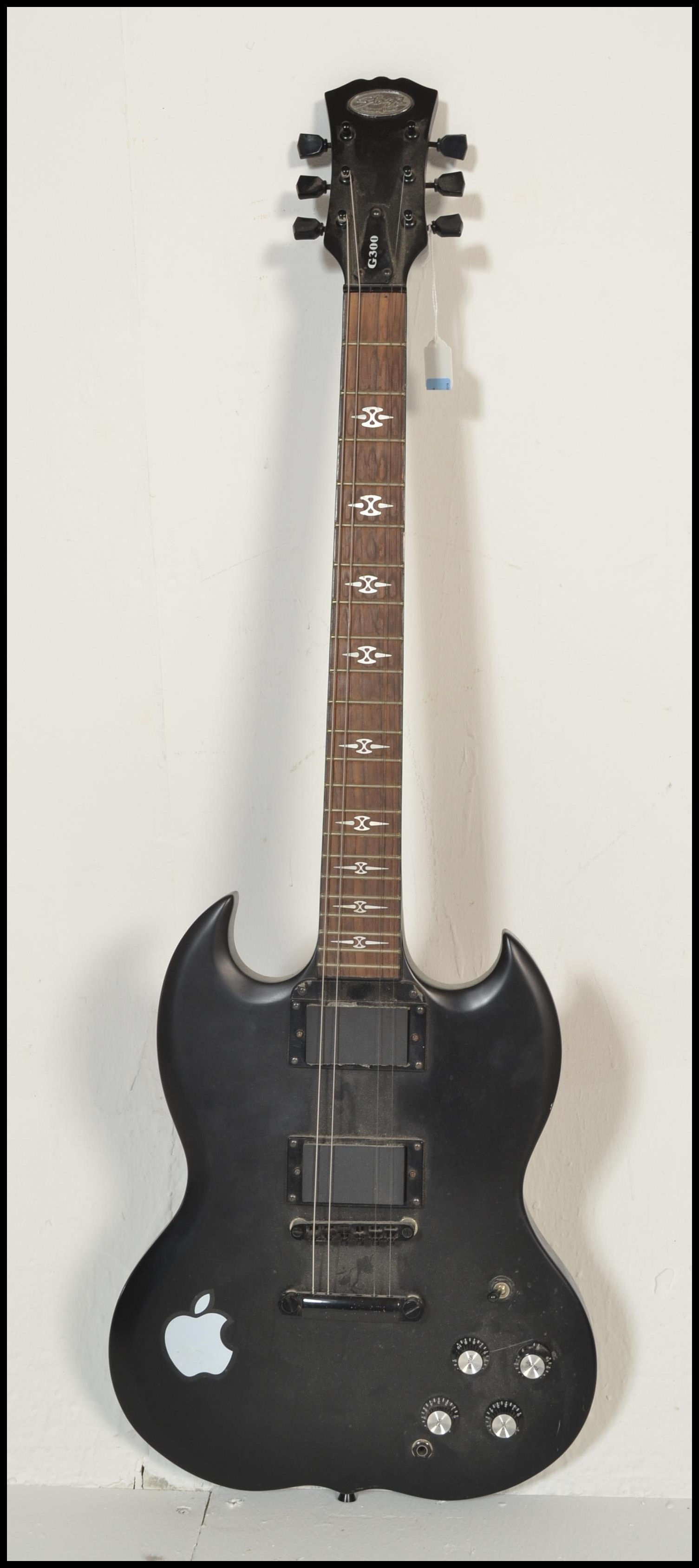 A Stagg G300 SG style six string electric guitar having black body with