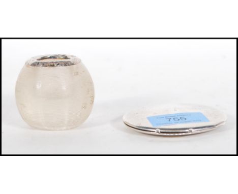 A silver hallmarked compact of round form having engine turned decoration with mirror to the inside (hallmarked Birmingham 19