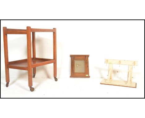 A mid century Danish inspired teak wood butlers serving trolley having twin tiers together with a mirror coat rack, another s