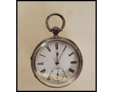 A silver hallmarked open face pocket watch dating from the late 19th century,&nbsp; having white enamel face with Roman numer