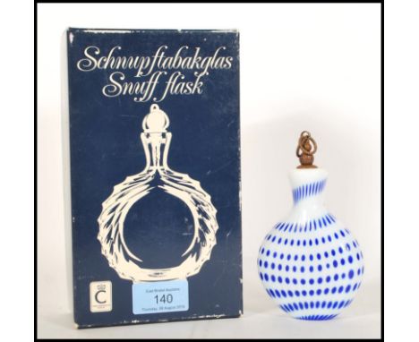 A 20th century Christinenhutte Schnupftabakglas snuff flask white glass bottle with mottled blue decoration having a metal st