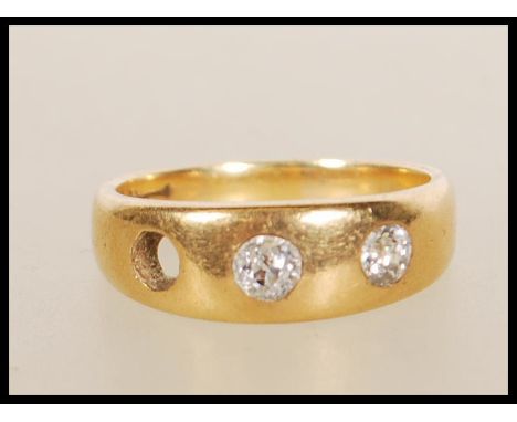 A stamped 18ct gold gypsy ring set with two round cut diamonds (the third is missing). Weight 6.8g. Diamonds estimated at 45 