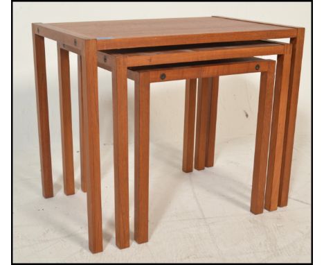 A 20th century retro vintage teak wood nest of tables of simple form with exposed finger joints to the corners. The tables ra