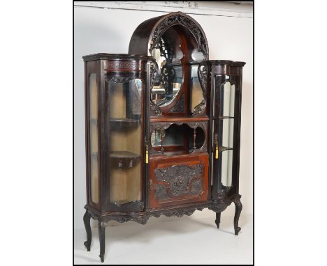 A 19th century Victorian large bow front and dome top vitrine display cabinet. Raised on cabriole legs with a central dome to