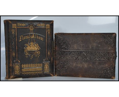 A 19th Century Victorian leather photograph album having metal lock with gilt page ends containing a collection of antique fa