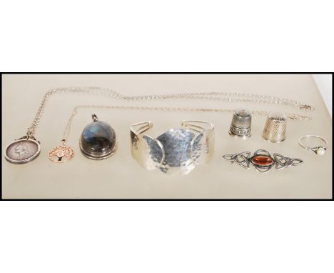 A small group of silver jewelry to include a Victorian coin in a silver mount on a chain, small tree pendant having white sto