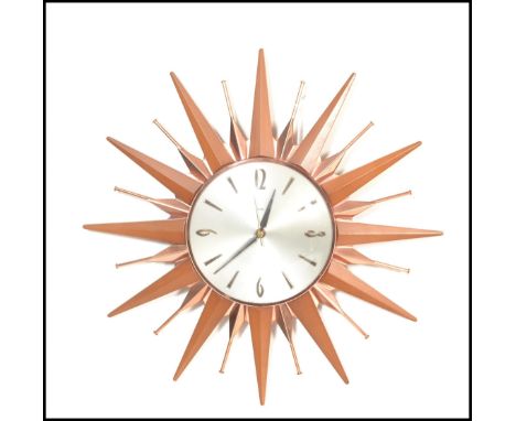An original retro vintage 1970's Metamec sunburst wall clock having Arabic and batten numerals to the silvered dial, with fau