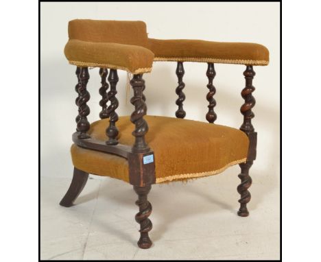 A Victorian barleytwist armchair raised on bobbin turned legs with yellow velour seat and elbow rests with barley twist galle