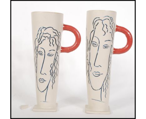 A pair of vintage studio pottery vases of cylindrical tapering form on square bases, decorated with minimalist drawings of wo