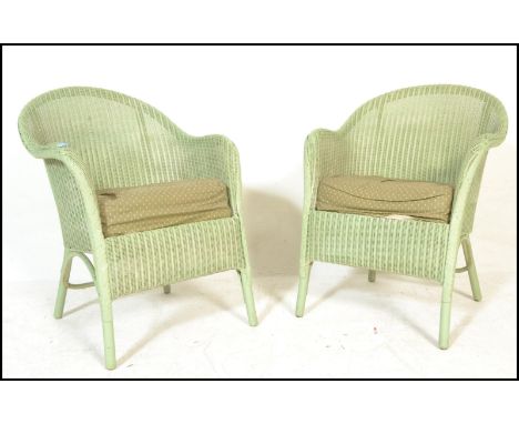 A matching pair of 20th Century wicker Lloyd Loom bedroom armchairs finished in light green having cushioned seats. Labels to