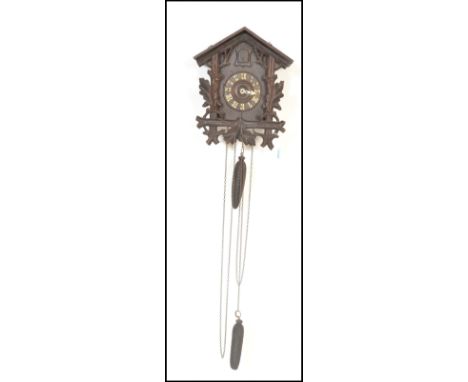 A 19th Century wall hanging Black Forest style cuckoo clock&nbsp;of architectural form, having white Roman numeral chapter ri