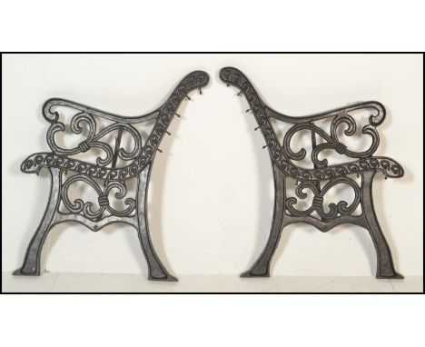 A pair of 20th Century cast iron scroll work garden bench ends together with a pair of metal scroll work wall hanging pot hol
