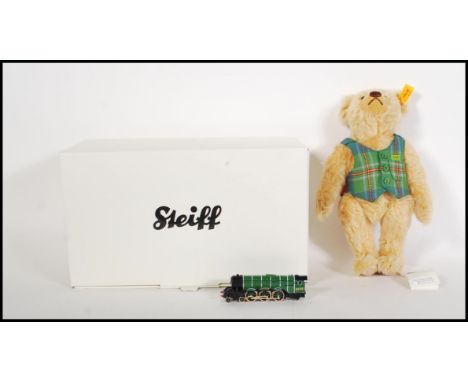 A boxed Steiff mohair teddy bear 004230 'Flying Scotsman' wearing a green scottish waistcoat, having original train ticket, l