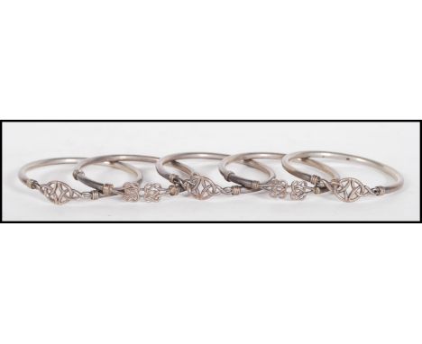 A group of five silver hallmarked bangles, each bangle having Celtic knot decoration. Hallmarks rubbed, stamps for 925. Weigh