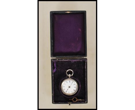 A late 19th Century silver hallmarked open face pocket watch having engraved decoration to the case. White enameled face with