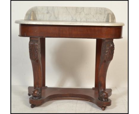 A Victorian 19th century mahogany and marble duchess console table. Raised on bun feet with lower tier having bow carved fron