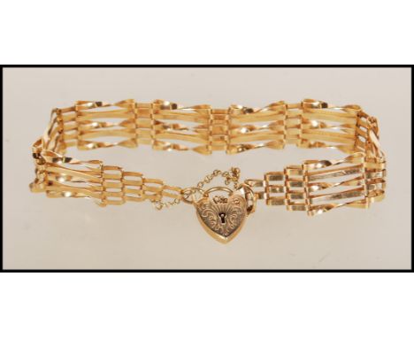 A hallmarked 9ct gold gate bracelet with tapered ends and attached heart-shaped padlock. Hallmarked london 1980. Weight 7.9g.