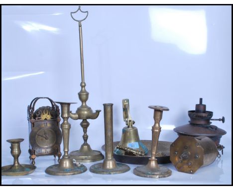 A collection of brass items dating from the 19th century onwards to include a brass mantel clock having a round face with rom