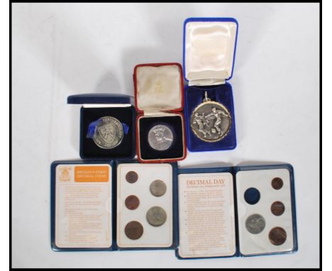 A silver Edward Prince of Wales coin in its original box together with two Britain's First Decimal Coins sets and vintage foo