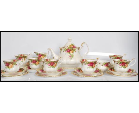 A vintage 20th Century Royal Albert bone China tea service for six in the Country Roses pattern consisting of teapot, creamer