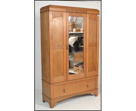 A late 19th / early 20th Century high Victorian light oak single door wardrobe having blind fretwork decoration with single m