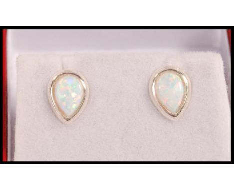 A pair of silver stud earrings set with pear shaped opal panels. Weight 1.1g.&nbsp;