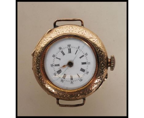 A marked 14ct gold wrist watch having chase decoration to front and verso with central monogrammed cartouche, white enamel fa