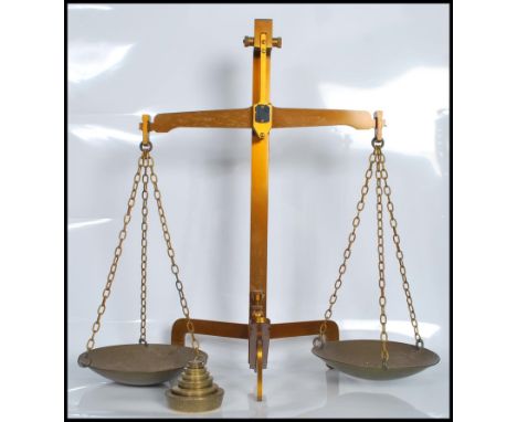 A set of 19th Century Victorian large brass balance grocers pan scales possibly by W.T. Avery raised on a tripod three footed