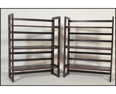 A pair of vintage style 20th Century wooden folding bookcases / traders display shelves. Three shelves to each and fold down 