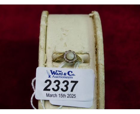 A 9ct gold single stone Ring with white cabochon stone and set in moissanite chip surround, size M, 1.7 grams.
