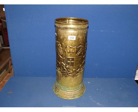 A brass stick stand with heraldic design.