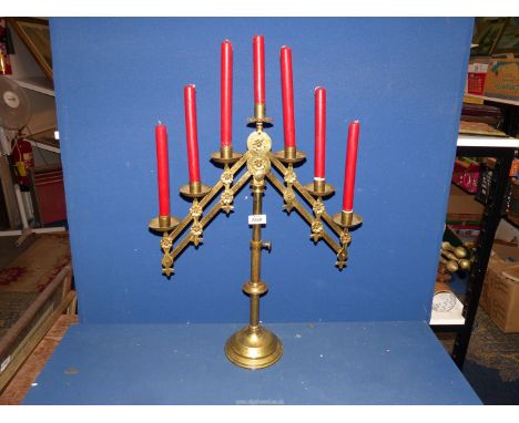 An adjustable and folding seven candle Benediction Candelabra. 
