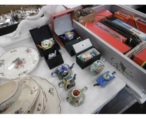 A qty of miniature enamel teapots