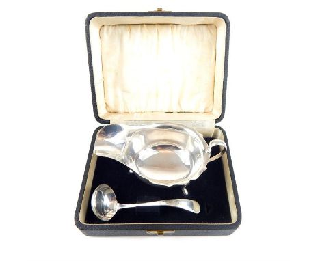 A cased solid silver sauce boat and ladle, Maker E.V, Gross Weight 132.grs 