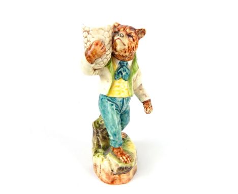 A ceramic figurine of a bear dressed in late 19th century dress holding basket aloft, stamped "4085 10"; 19.5cm high; small c