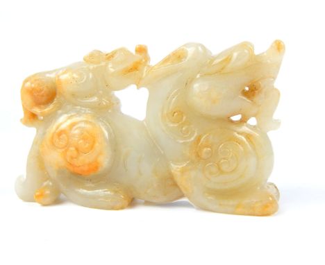 A Chinese mutton fat carved jade dragon; 9.5cm long. 