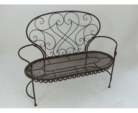 A bronzed metal garden bench, having scrolling details to the back and open arms, 95 x 130 x 55cm.