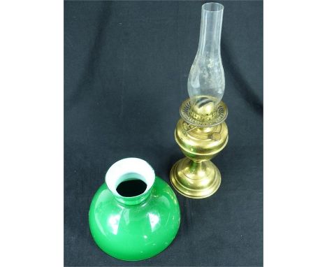 A vintage brass oil lamp with chimney and associated green glass shade; the lamp stamped "V" to its base.